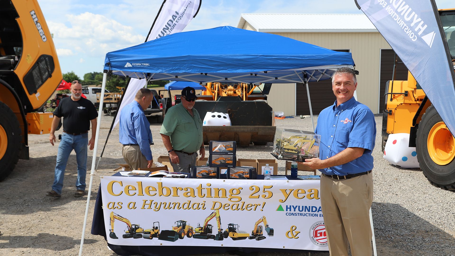 Greg Newell George & Swede Sales & Service, Owner Poses With the Hyundai Dealer 25 Year Anniversary Golden Excavator Award
