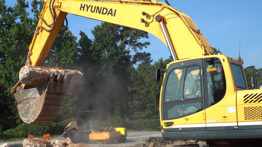 Hyundai 330LC-9A excavator carrying concrete slab